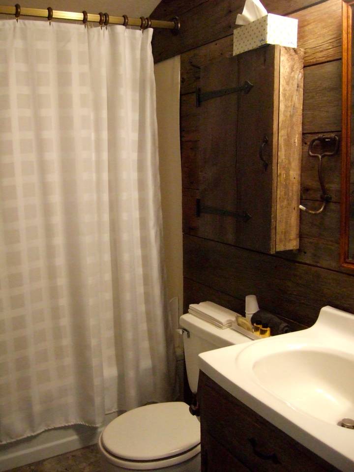 Full bath finished with barn board siding.